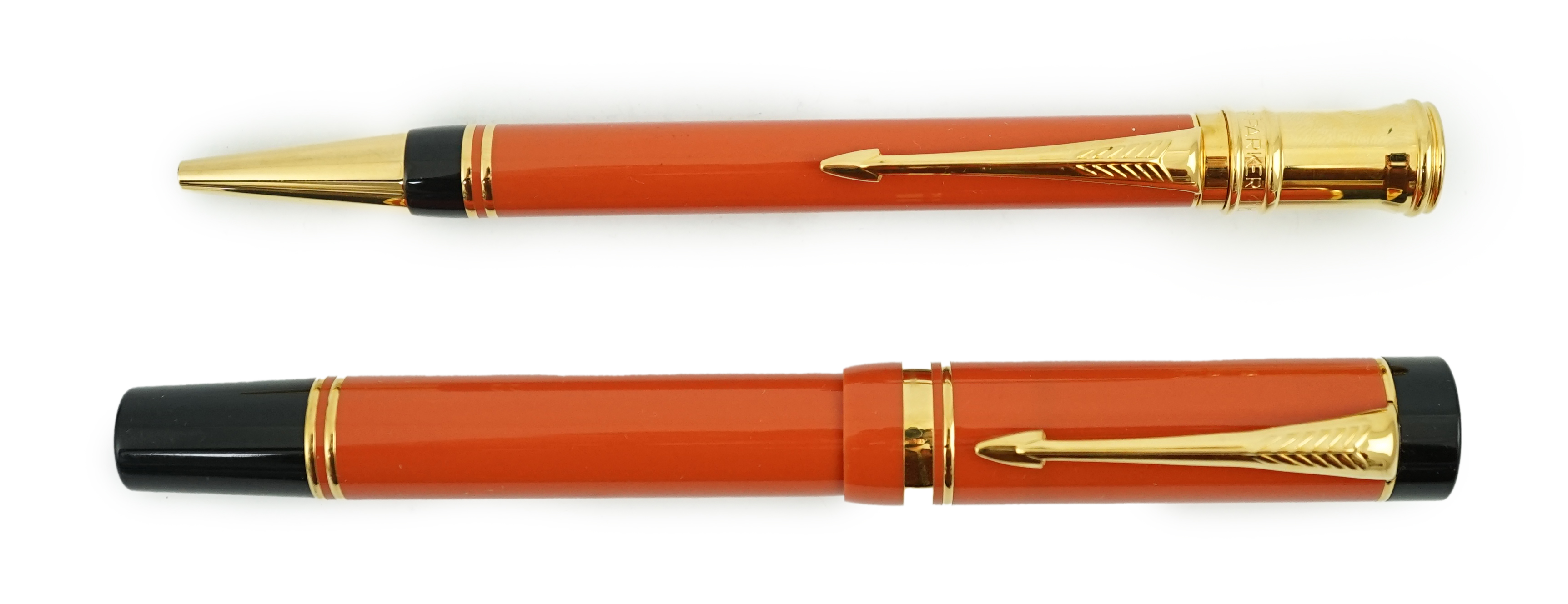 A Parker Duofold orange centennial fountain pen and pencil set, in wooden case